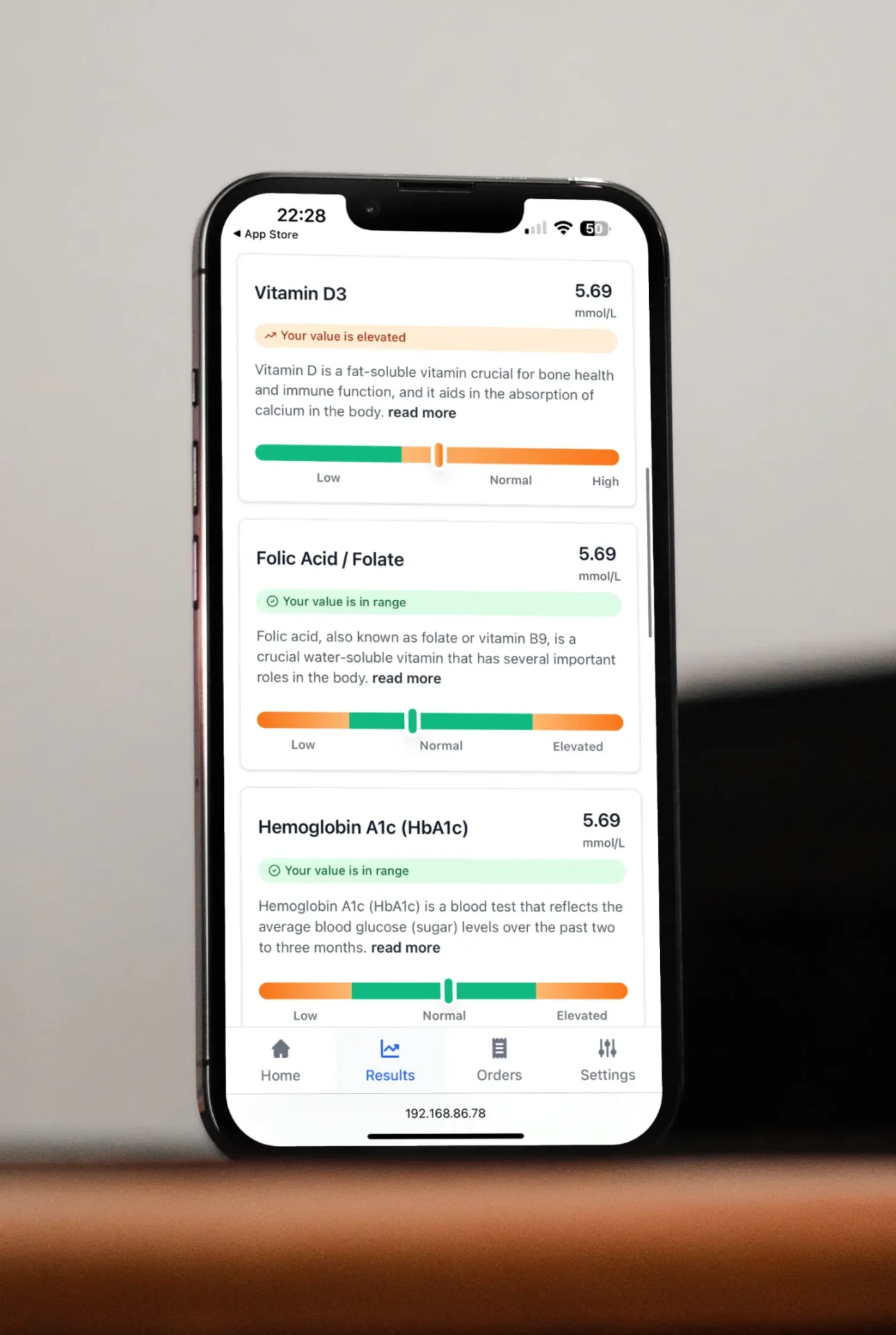 Healthtrackr biomarker results app showing Vitamin D3, Folic Acid, and HbA1c readings on a phone